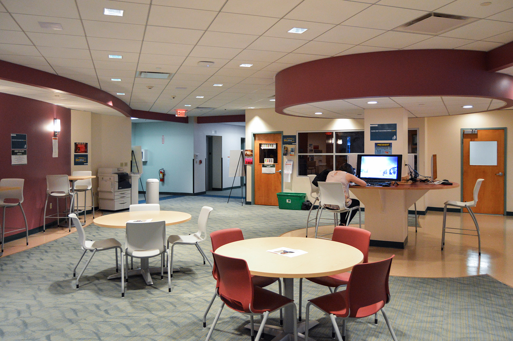 Quincy College student center seating area with tables