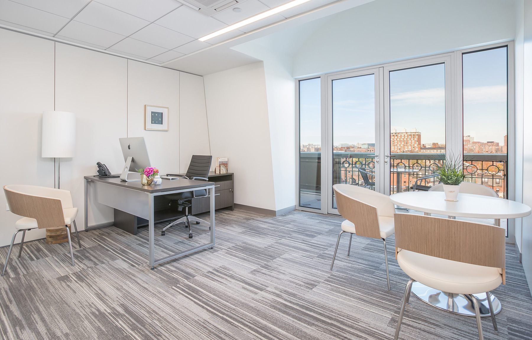 SnapSuites office with desk and view of Boston